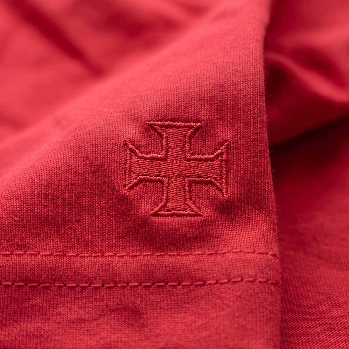 Détail broderie croix de l'Ordre du Christ sur l'ourlet du t-shirt rouge LusiTuga